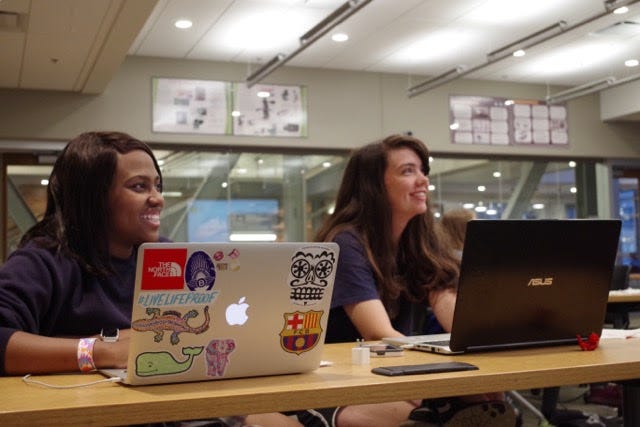 Two students at their computers in a coding class